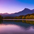 Serene sunset sky reflected on tranquil lake with misty mountains and trees