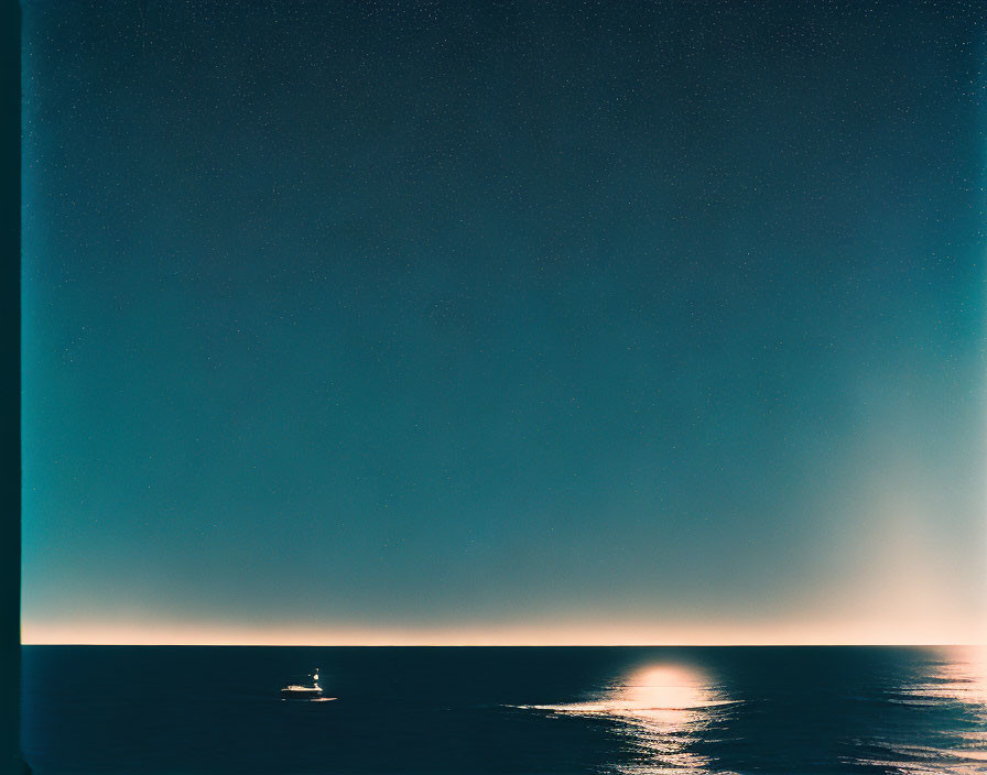 Yacht sailing on calm sea under starry sky with visible horizon light