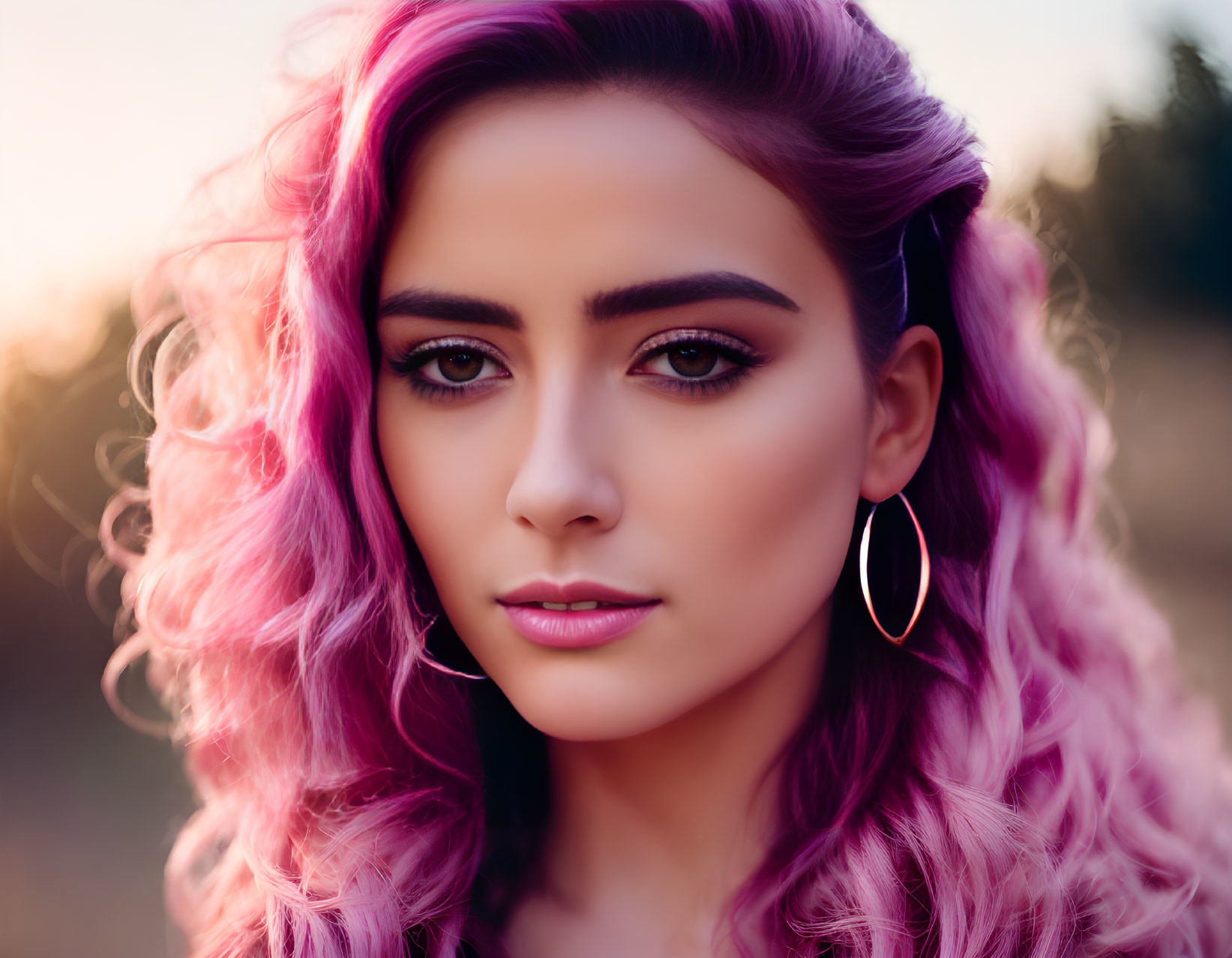 Vibrant pink hair and winged eyeliner makeup in outdoor portrait