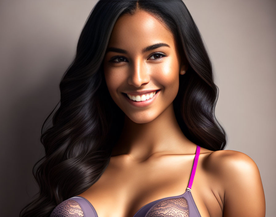 Smiling woman with long wavy hair in purple strap top