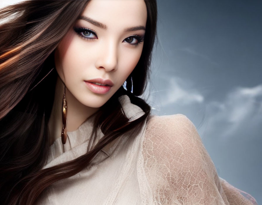 Dark-haired woman with bold makeup against stormy sky.