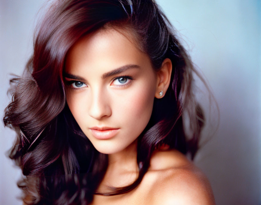 Woman with Dark Wavy Hair and Intense Gaze Portrait