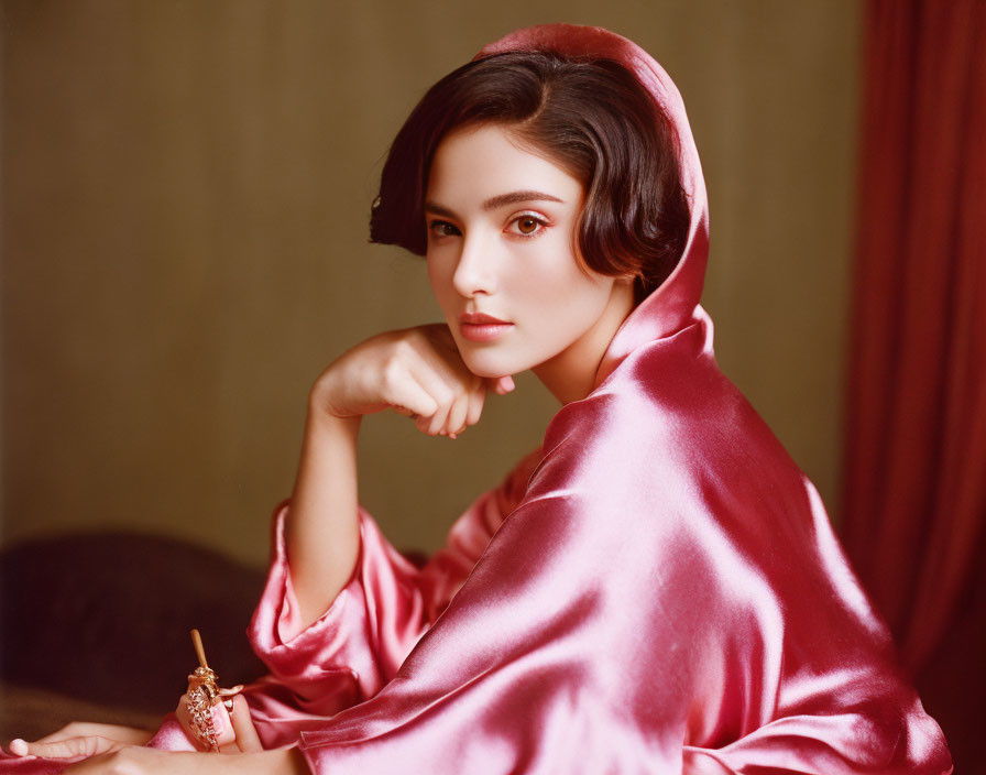 Dark-Haired Woman in Pink Satin Headscarf and Robe Gazes at Camera