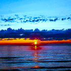 Scenic ocean sunset with warm glow and dark clouds