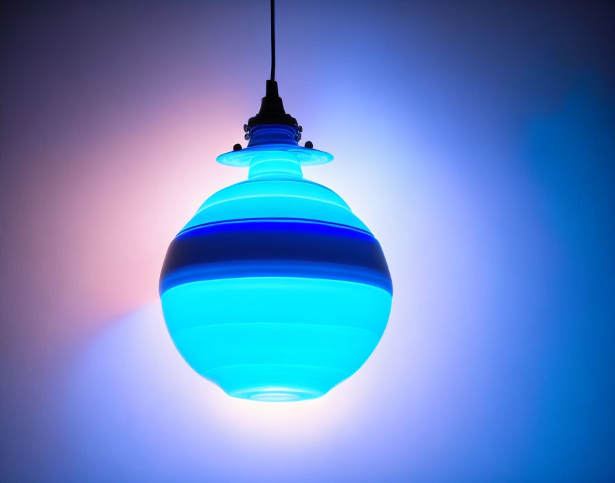 Blue Pendant Lamp with Dark Stripes Against Pink and Blue Wall