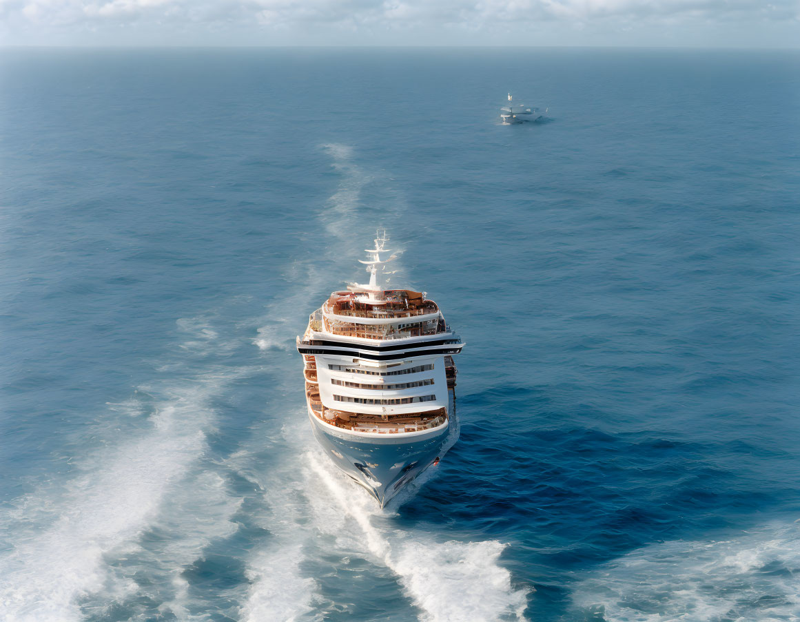 Cruise ship sailing on vast ocean under clear skies