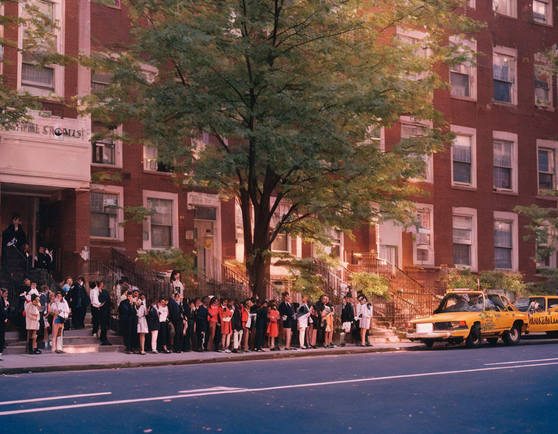 Formal Attired Group Waiting Outside Red Brick Building