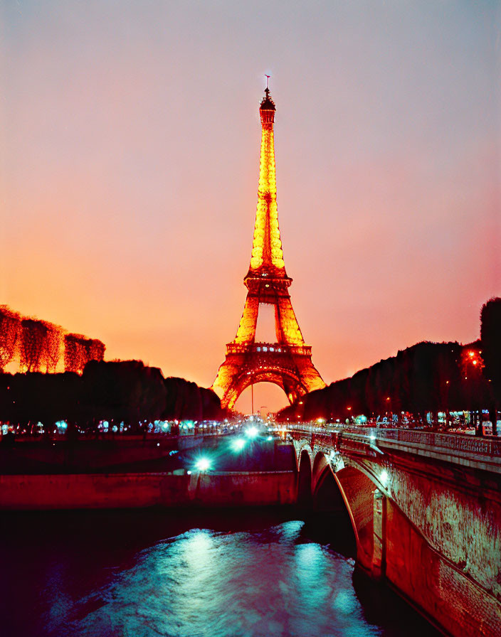 Iconic Eiffel Tower at dusk with fiery sky and Seine River view