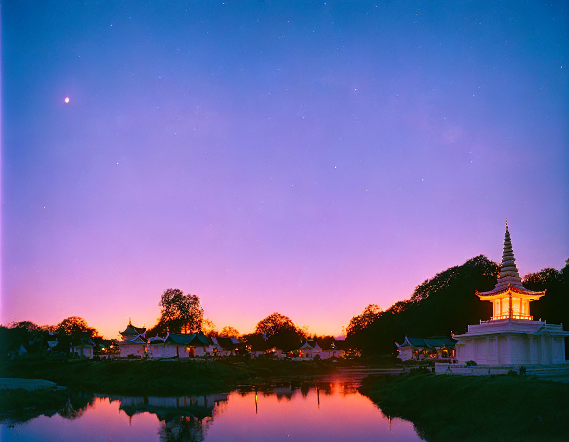 Purple to Orange Twilight Sky Reflecting Temple and Stupa by Tranquil Pond