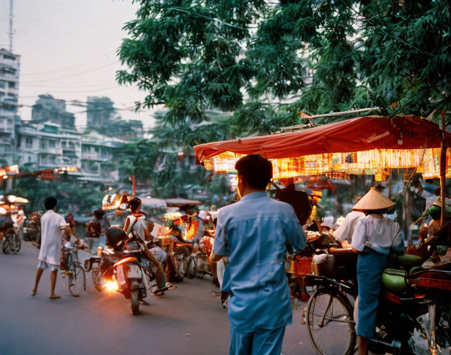 Busy Asian City Street Scene at Dusk with Food Stalls and Motorbikes