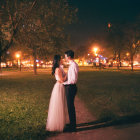 Couple under starry sky by Christmas tree and street lamp