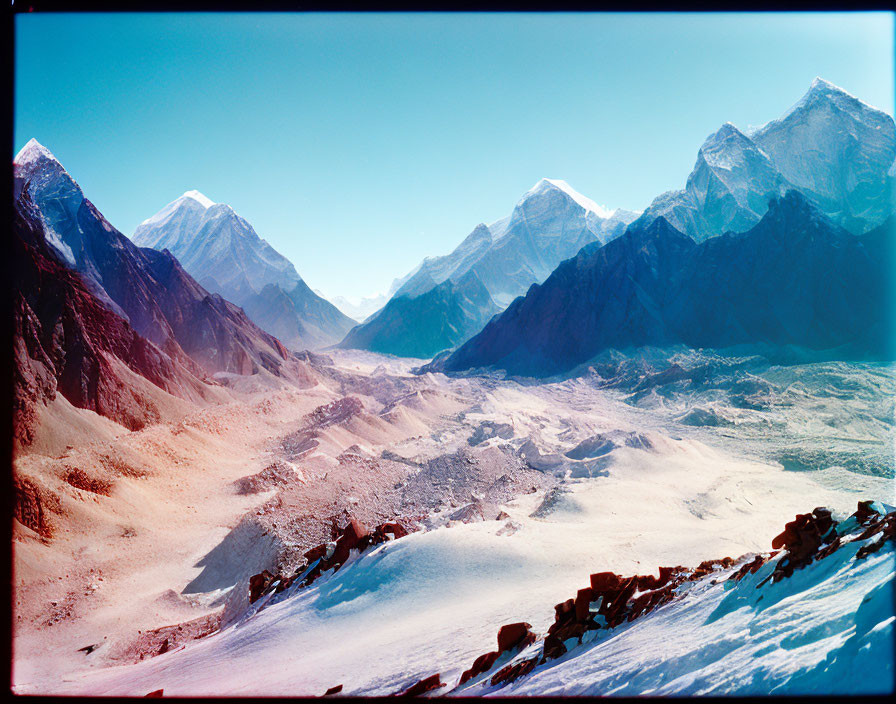 Snowy Mountain Range with Clear Sky and Valley Landscape