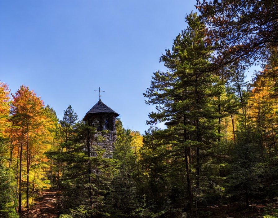 Stone Chapel with Cross in Autumn Forest Clear Blue Sky