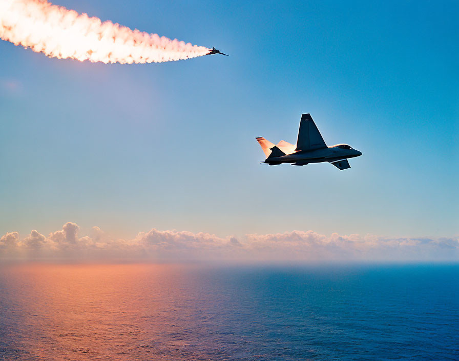 Military fighter jet with contrails over ocean at sunset.