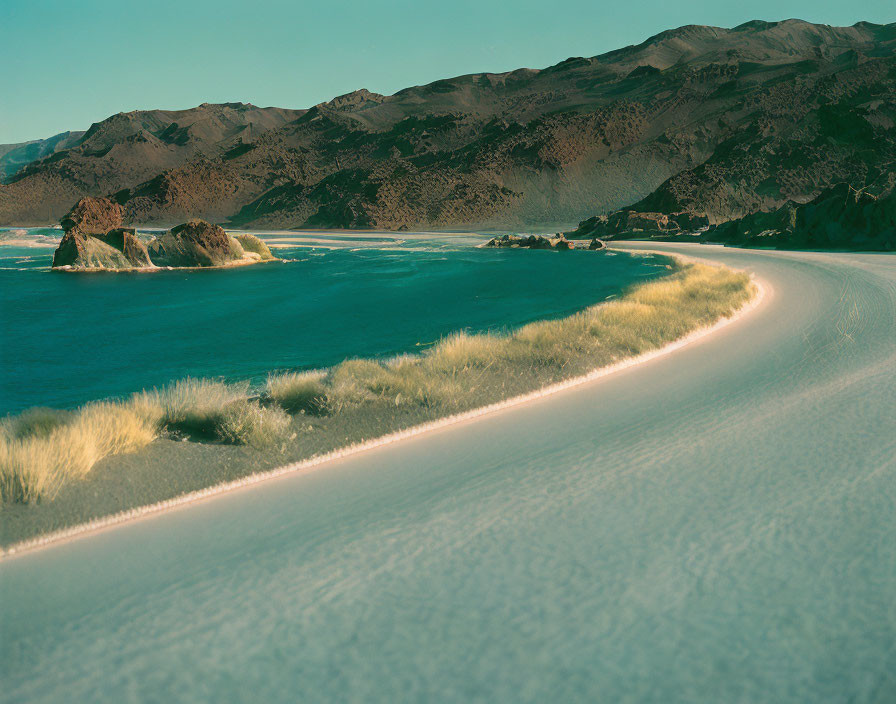 Tranquil Coastal Landscape with Sandy Shore and Rocky Islets