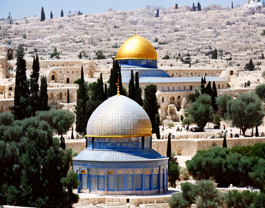 Golden dome and blue walls of Dome of the Rock in Jerusalem with greenery and sunny skyline