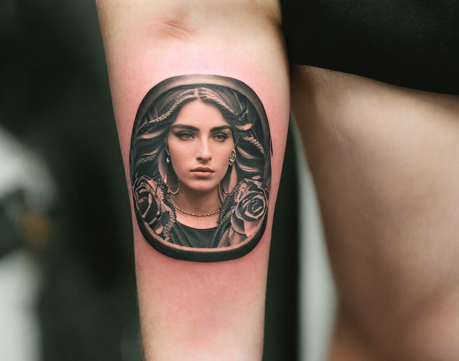 Detailed Woman Portrait Tattoo with Oval Frame and Rose Motifs on Forearm