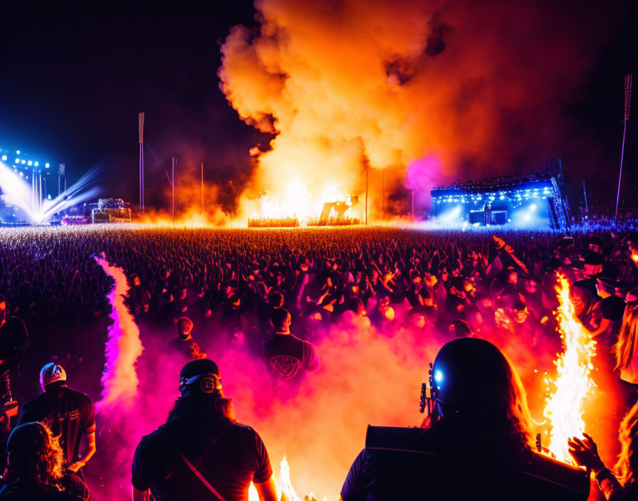 Outdoor Concert: Large Crowd, Intense Stage Lighting, Orange Smoke