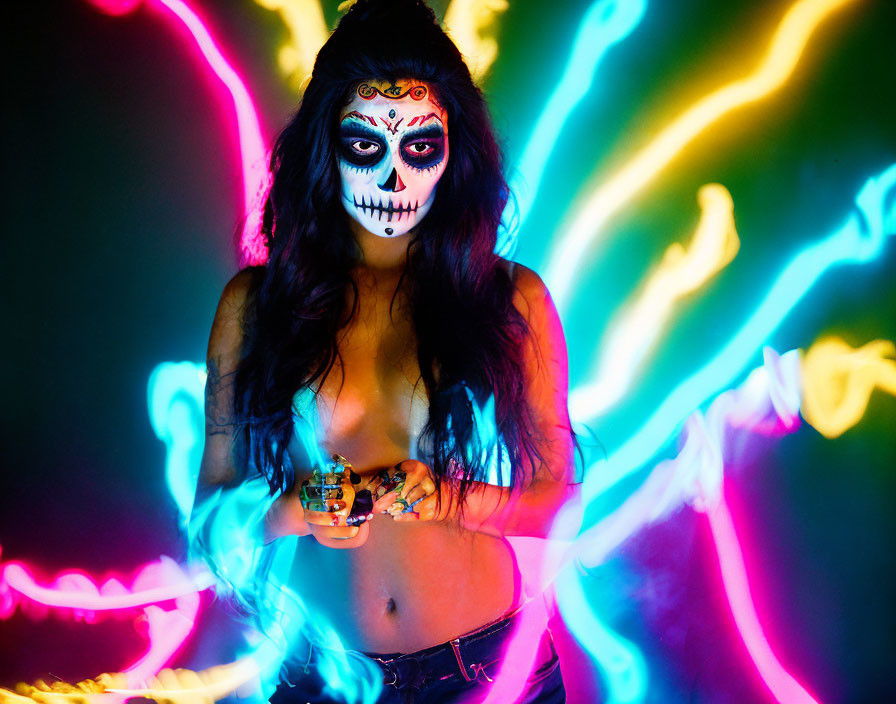 Day of the Dead face makeup woman in neon light trails with small object, bikini top, jeans