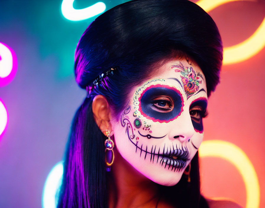 Elaborate skull face paint on person against neon-lit background