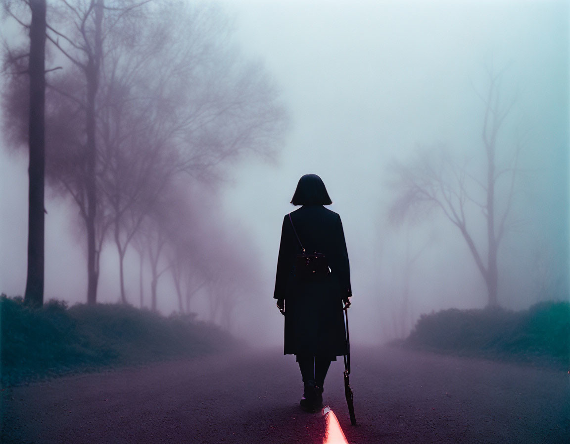 Mysterious figure with red lightsaber on foggy road