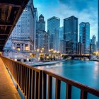 Urban night skyline with skyscrapers, bridge, and river lights