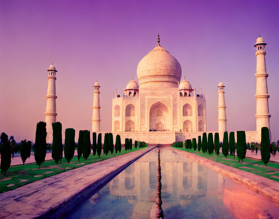 Iconic Taj Mahal Sunset Reflection in Water with Vibrant Purple Hues