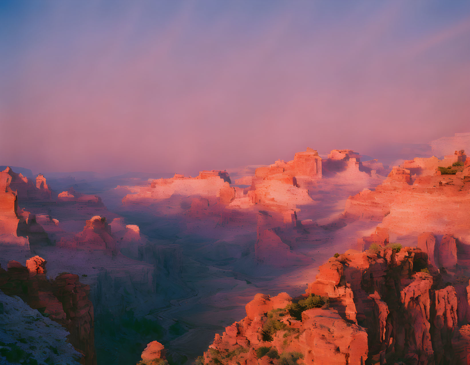 Sunset illuminating rocky canyon formations in warm light