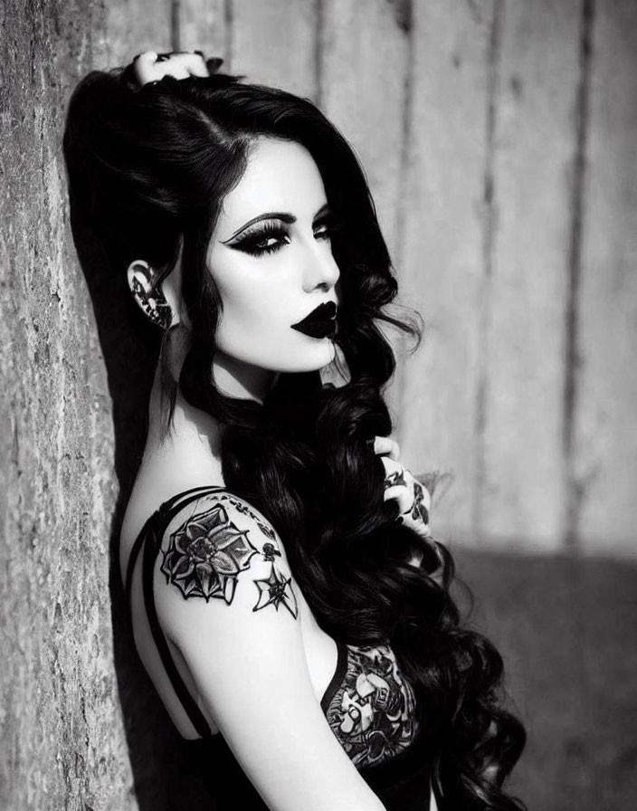 Monochromatic portrait: Woman with dark lipstick, tattoos, lush hair