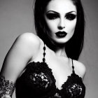 Monochromatic portrait of woman with dark makeup, teardrop accents, rose tattoos, and black