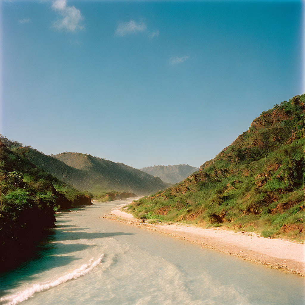 Tranquil River in Sunlit Valley with Green Hills