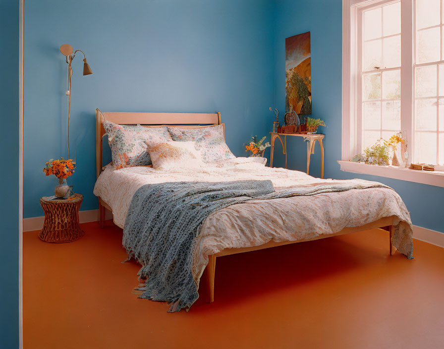 Blue and Orange Bedroom Decor with Patterned Bedding and Wall Painting