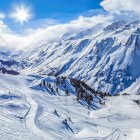 Snowy Mountain Range with Glacier and Sunlit Peaks