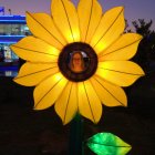 Sunflower-shaped house illustration under starry sky with glowing petals and moon