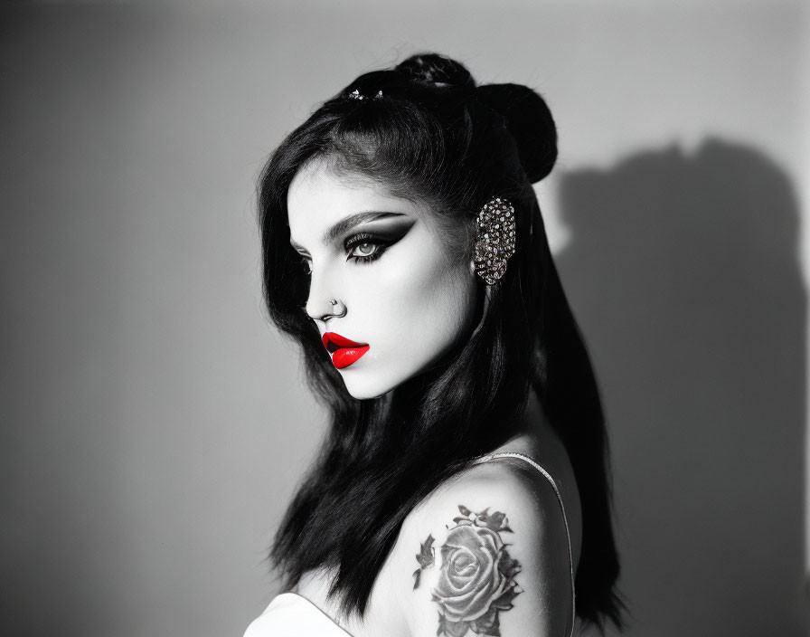 Monochrome portrait of woman with red lipstick and winged eyeliner