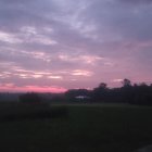 Vibrant sunset and starry sky over vast twilight grassland