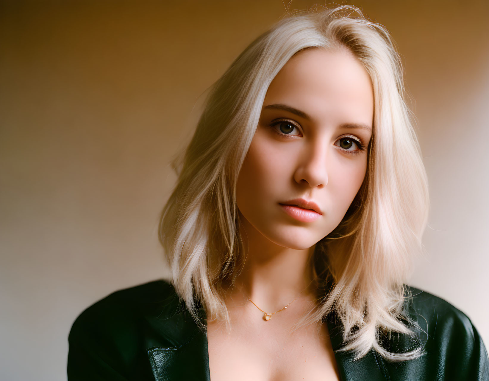 Blonde Woman in Black Jacket Portrait on Soft Background