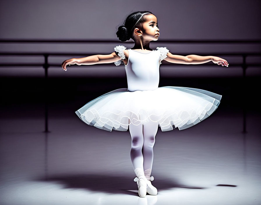 Young ballerina in white tutu practicing on stage under spotlight