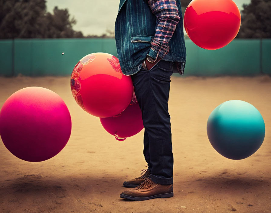 Person in denim jacket surrounded by colorful balloons in jeans outfit