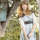 Auburn-Haired Princess in Blue Dress Amid Sunlit Forest