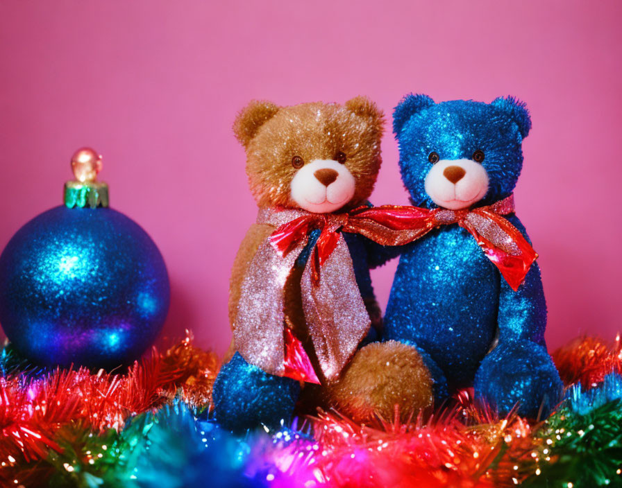 Brown and blue teddy bears with shiny bows in festive setting on pink background.