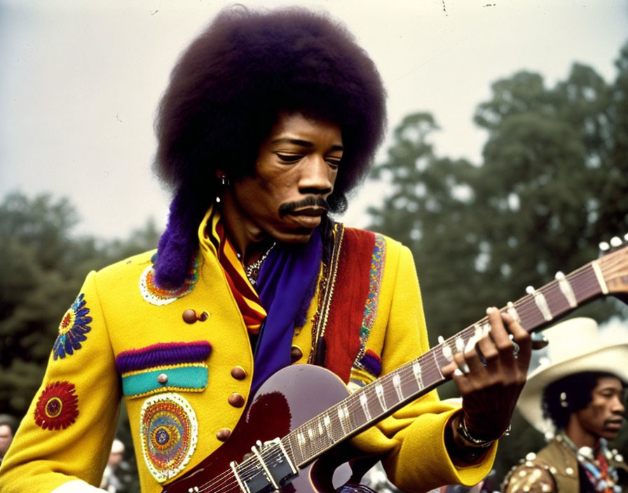 Man with Afro Playing Guitar in Vibrant Yellow Jacket