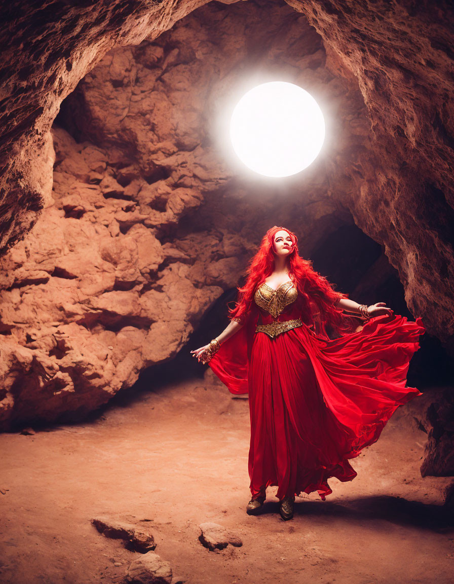 Red-haired woman in vibrant dress standing in glowing cave