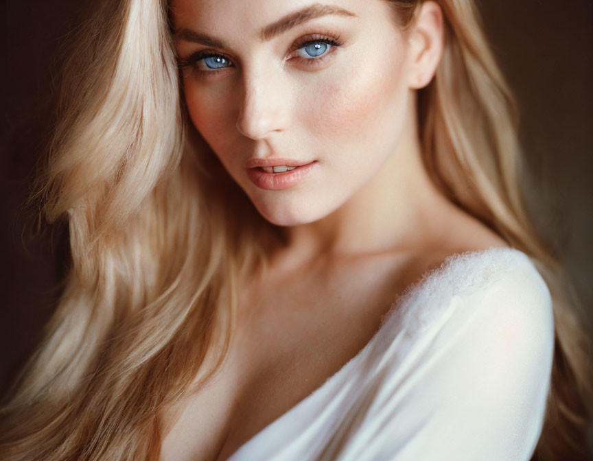 Blonde woman portrait with blue eyes and white garment