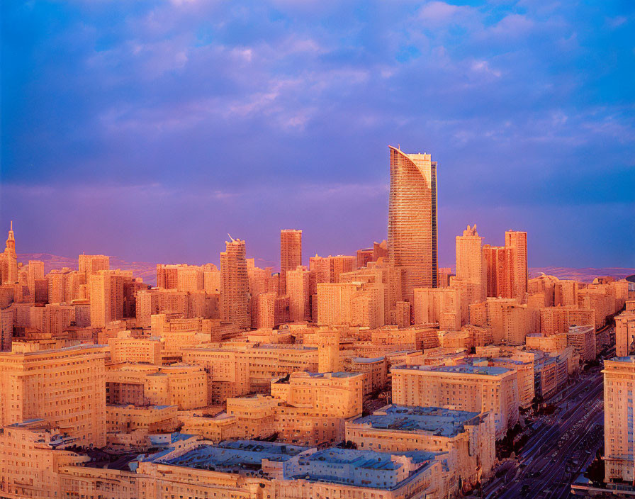 Urban sunset cityscape with warm light on high-rise buildings and a unique curved skyscraper.