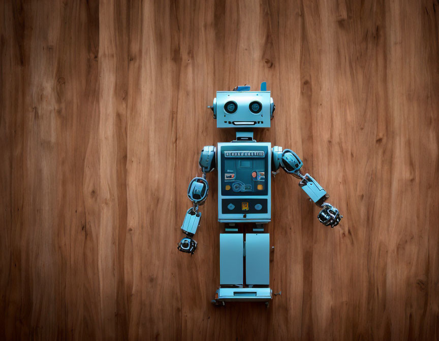 Blue-gray toy robot disassembled on wooden surface