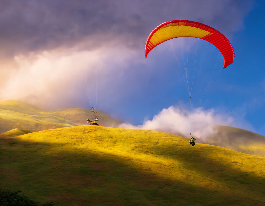 Colorful Paraglider Flying Over Green Hillside