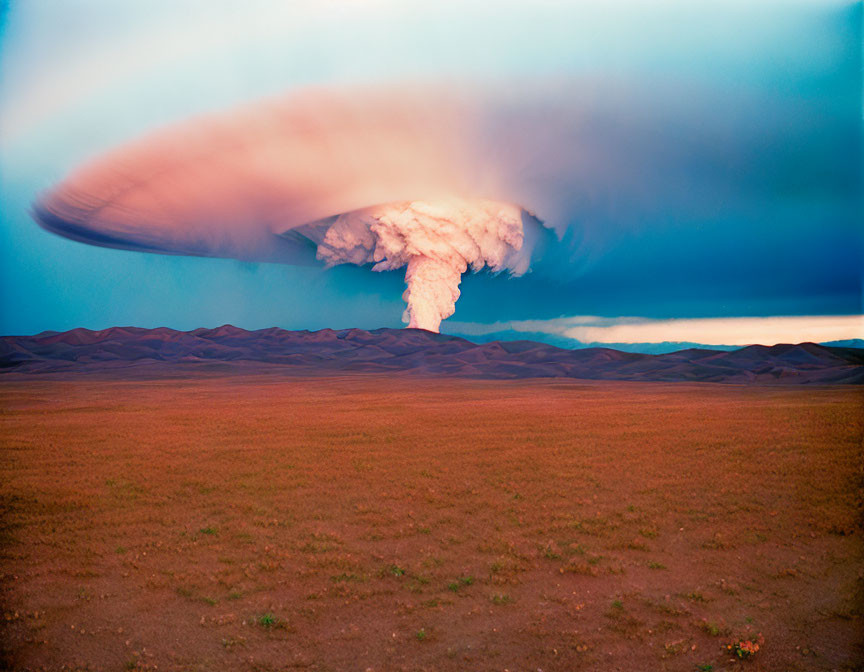 Barren land under dramatic sky with ominous mushroom cloud formation