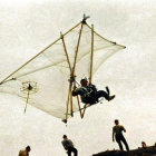 Hang glider soaring above beach with onlookers and dog, waves and misty sky.