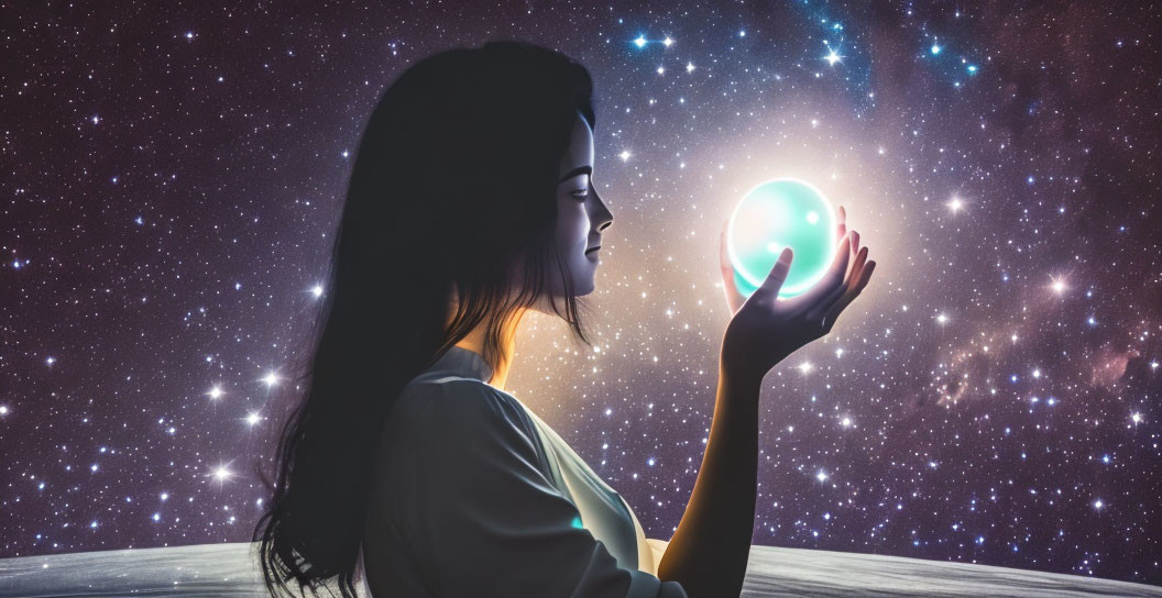 Woman holding glowing orb against starry night sky background